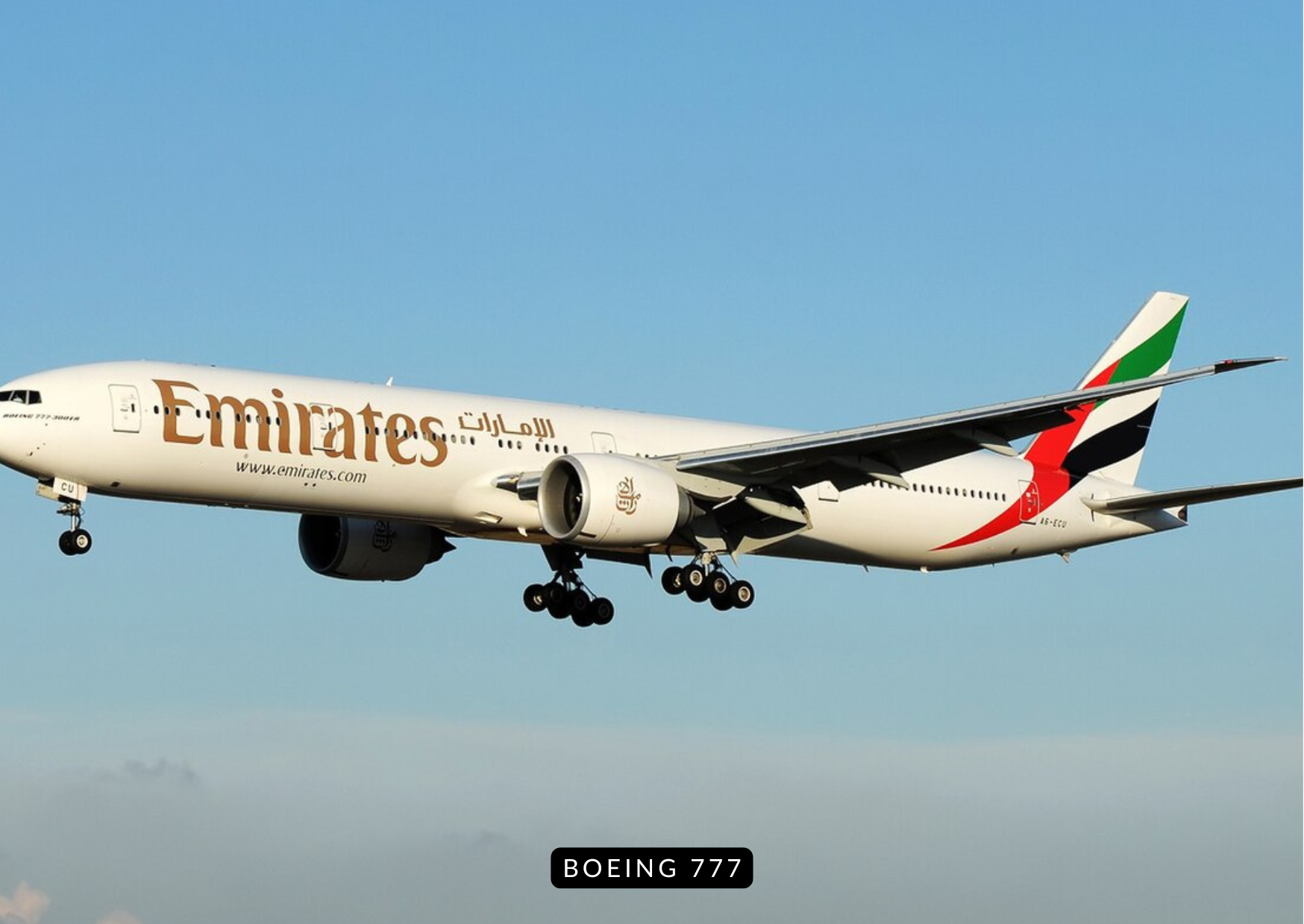Boeing 777 taking off in golden light with landing gear retracting