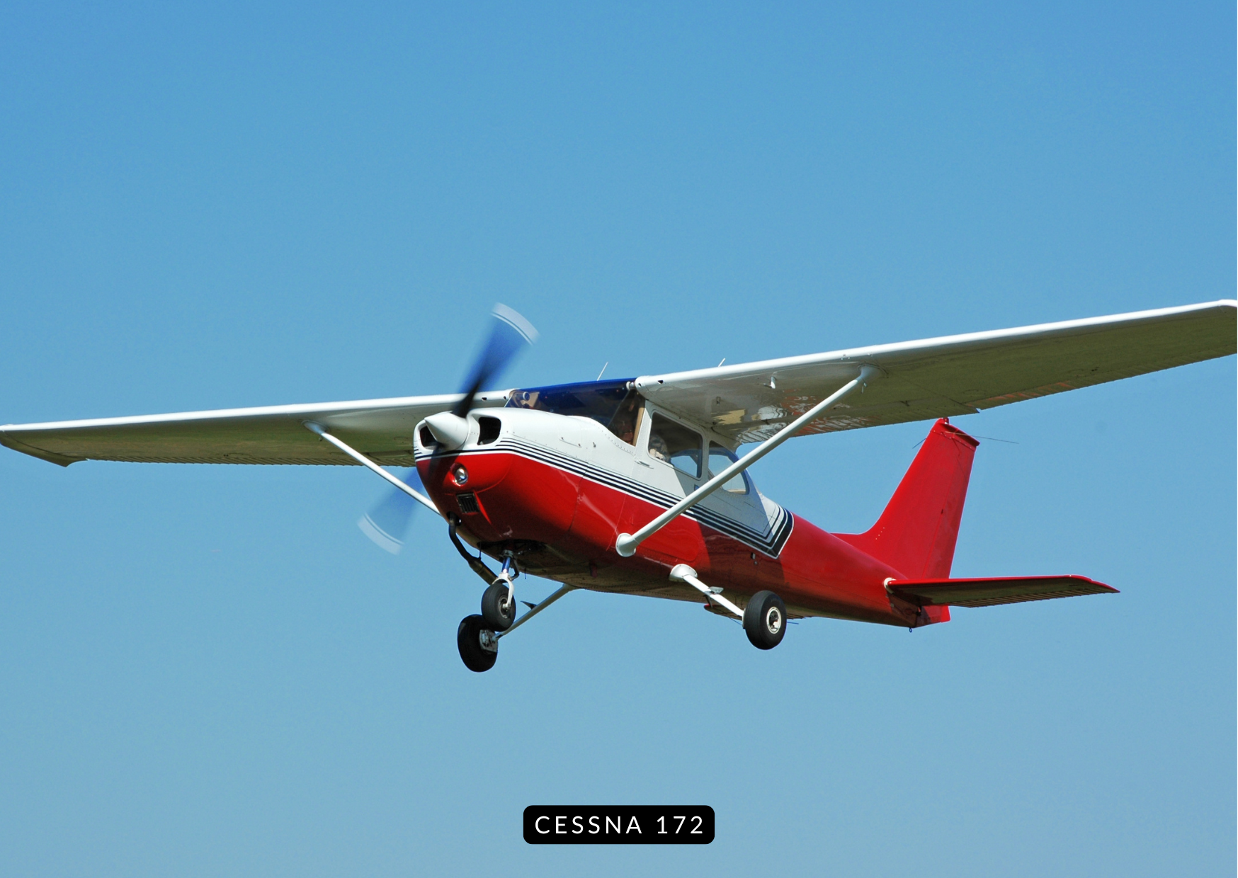 Cessna 172 flying low over green countryside